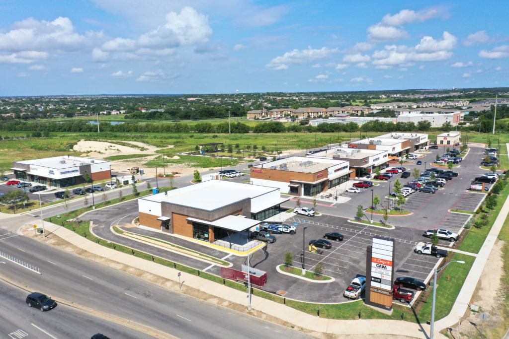 Aerial view of Kyle Crossing retail center in Kyle, Texas, ground-up construction by Synergy Commercial Construction featuring multiple retail buildings and parking areas