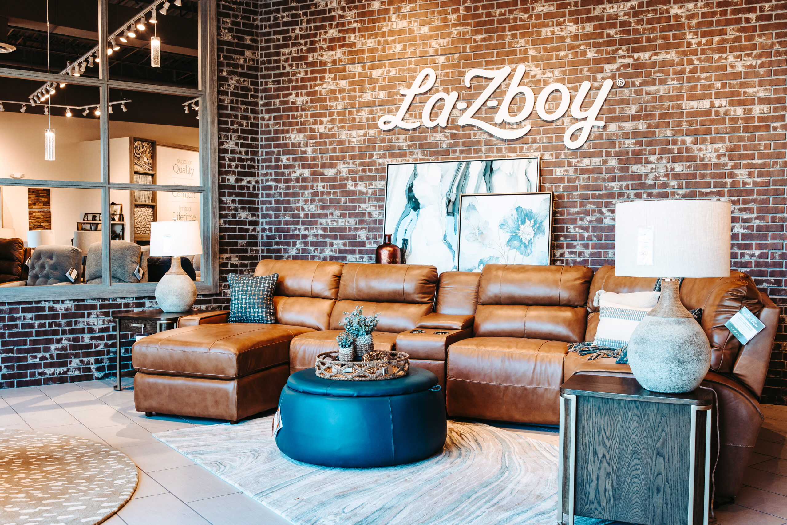 La-Z-Boy showroom seating area with leather sofas and branded feature wall built by Synergy Commercial Construction