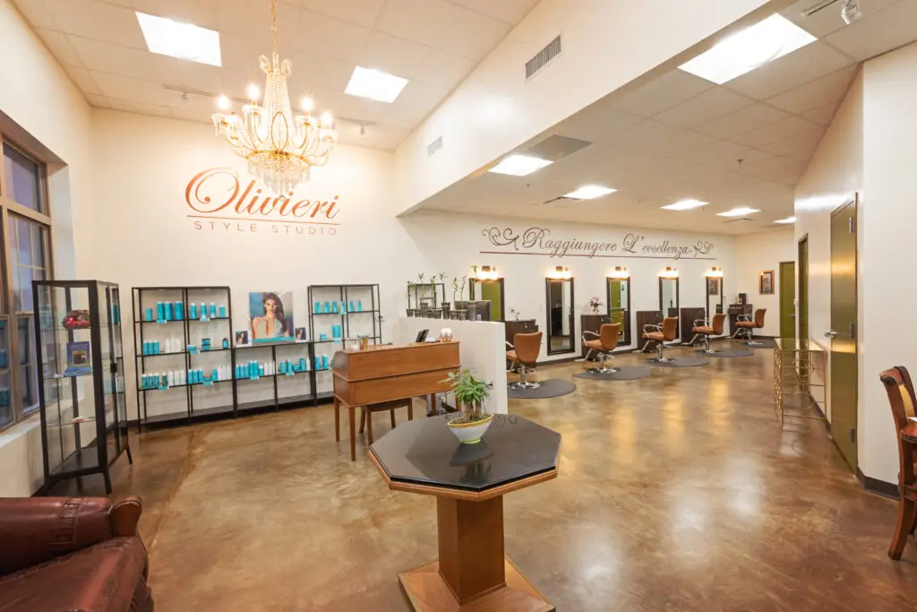 Wide interior view of Olivieri Style Studio hair salon with styling stations and open layout by Synergy Commercial Construction