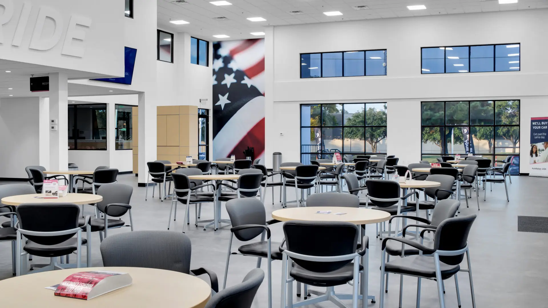 Customer waiting and showroom area inside AutoNation USA Plano featuring new flooring, seating layouts, lighting, and interior finishes as part of the commercial renovation.