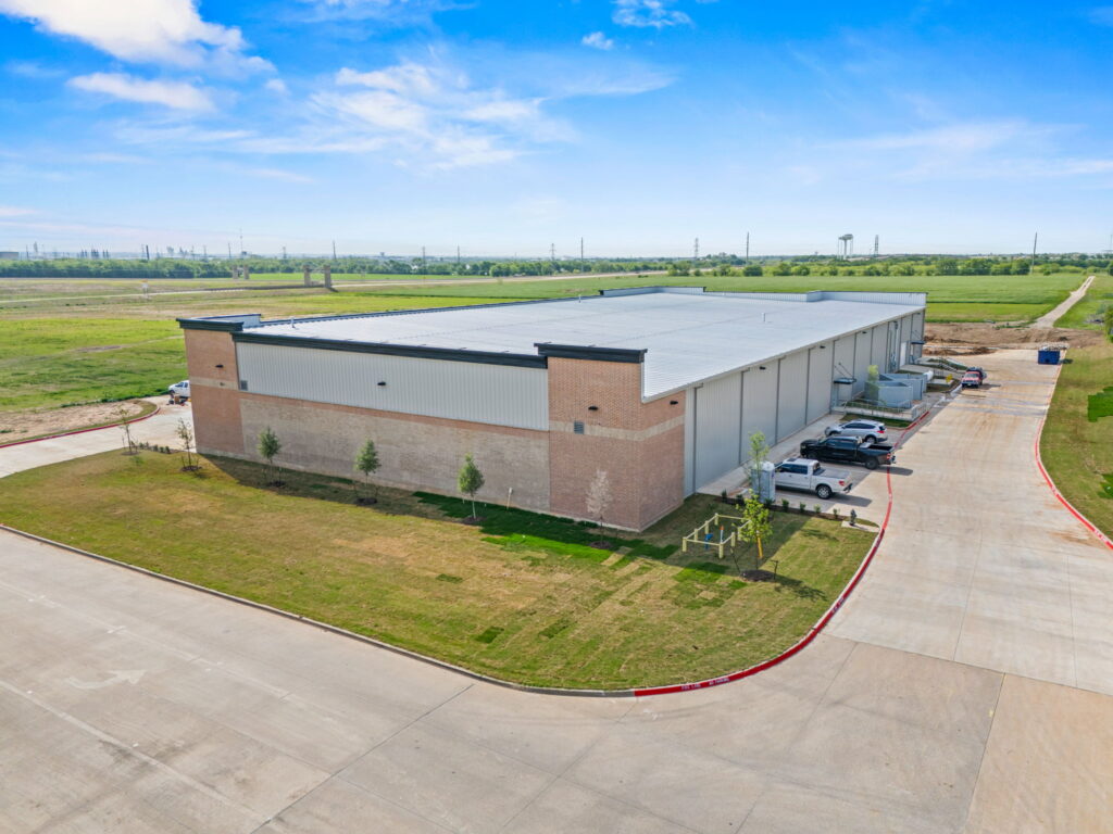 Elevated aerial overview of the Cleburne Warehouse completed by Synergy Commercial Construction in Cleburne, Texas.