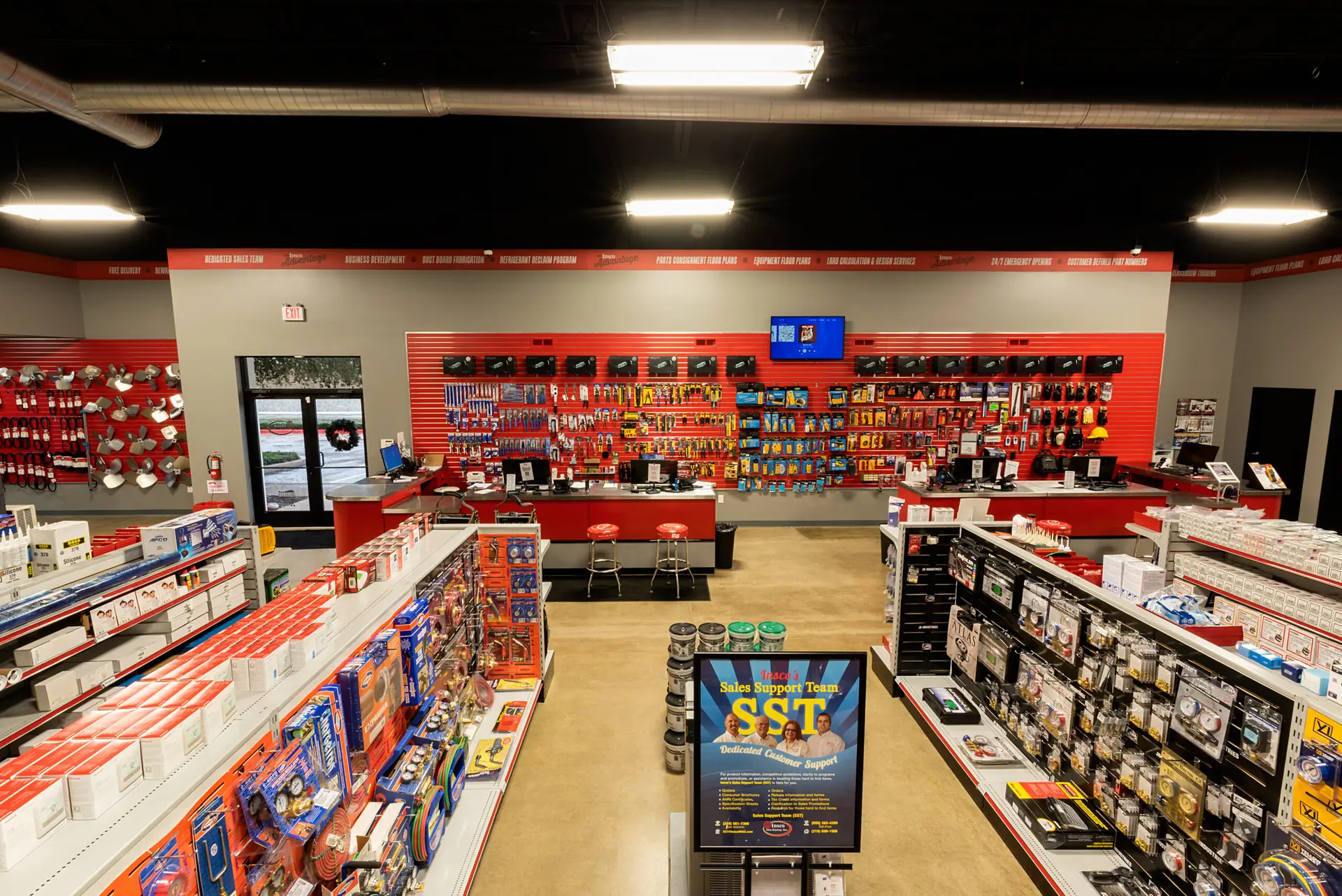 Front sales and customer service area at the Insco facility with stocked product displays, service counters, and showroom improvements completed by Synergy Commercial Construction.